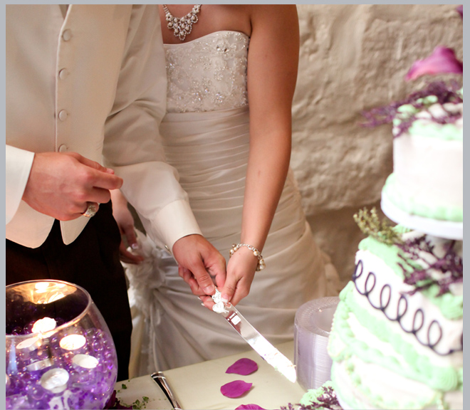 Bride and Groom Cutting Wedding Cake by Pedigo Photography