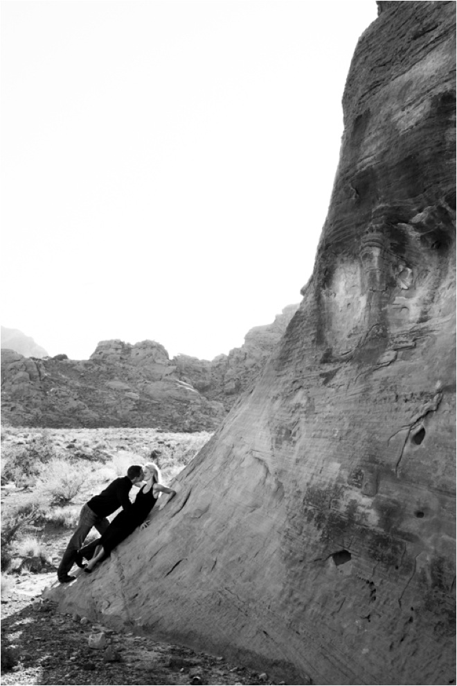 Leaning against a rock wall