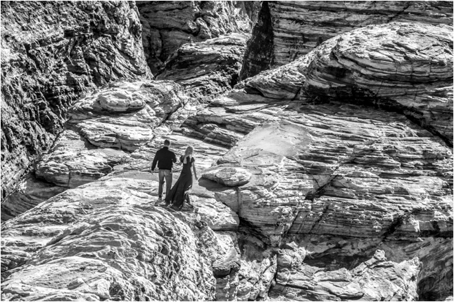 Couple walking on rock black and white