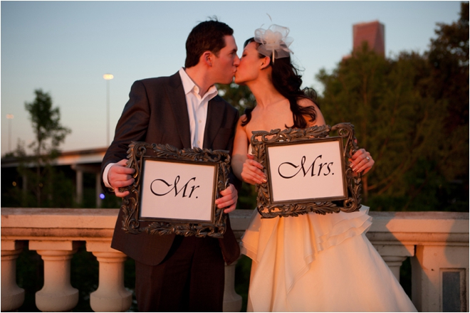 Bride and Groom kissing with Mr. & Mrs. signs