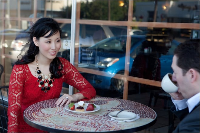 Bride and groom sitting outside cafe