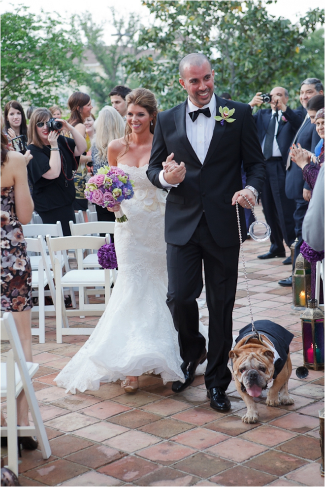 couple walking down aisle with dog