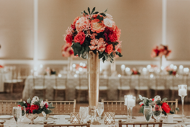 real wedding houston wedding the woodlands resort & conference center wedding reception decor pink and coral floral centerpiece gold vase gold chiavari chairs candlelit tables