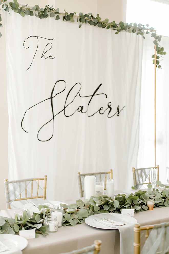 reception decor, grey, gold, white, eucalyptus, backdrop, cloth, candles, simple, elegant