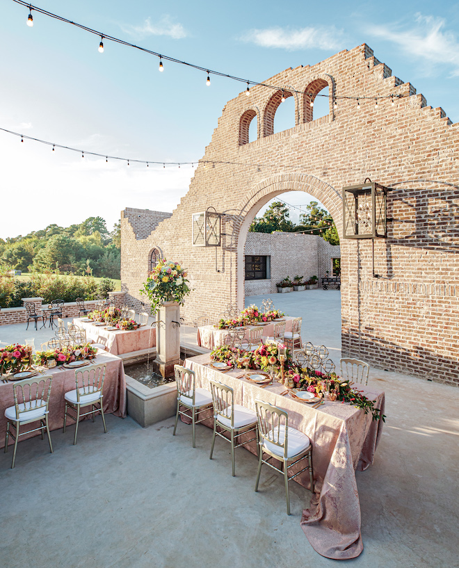 rehearsal dinner decor, table setting, outdoor, courtyard, floral centerpieces, gold flatware, gold chargers, beautiful, vibrant, unique, peach linens, iron manor, kirksey gregg productions, ama by aisha