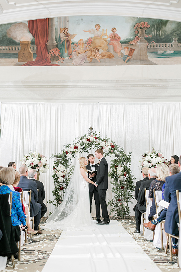 fall wedding, mauve, blush, creams, floral arch, greenery, white aisle runner, rose petals, bridal veil, ceremony decor, romantic