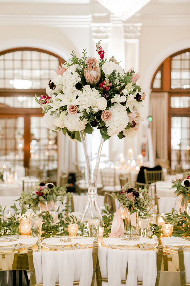 reception decor, greenery runner, floral centerpieces, gold place setting, candles, fall wedding, romantic, flowers, tall centerpieces