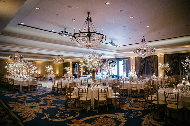 enchanted wedding, white orchids, candles, cherry blossom trees, floating candles, orbs, tall tapered candles, reception decor, white linens, the houstonian