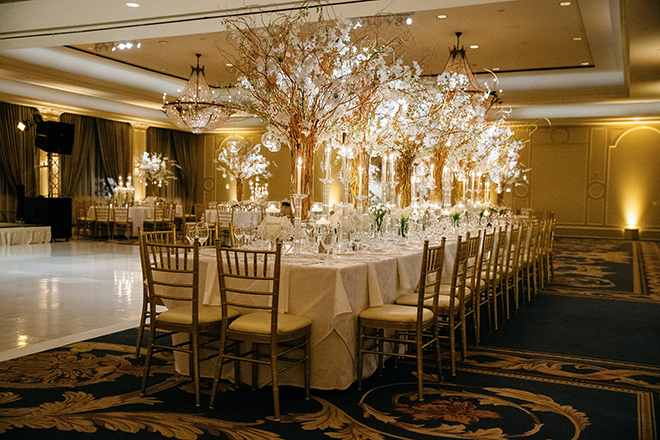 enchanted wedding, white orchids, candles, cherry blossom trees, floating candles, orbs, tall tapered candles, reception decor, white linens, the houstonian