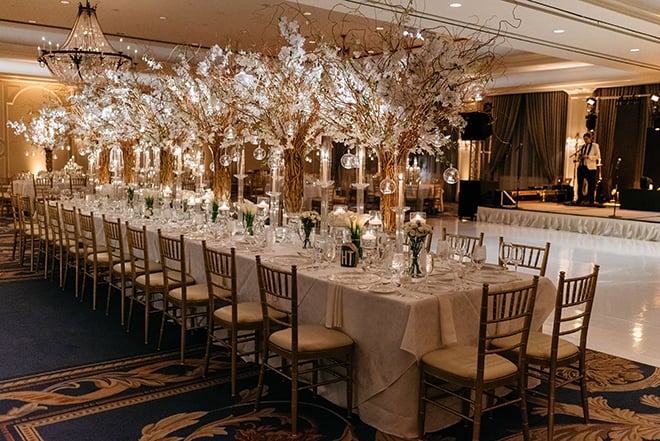 enchanted wedding, white orchids, candles, cherry blossom trees, floating candles, orbs, tall tapered candles, reception decor, white linens, the houstonian