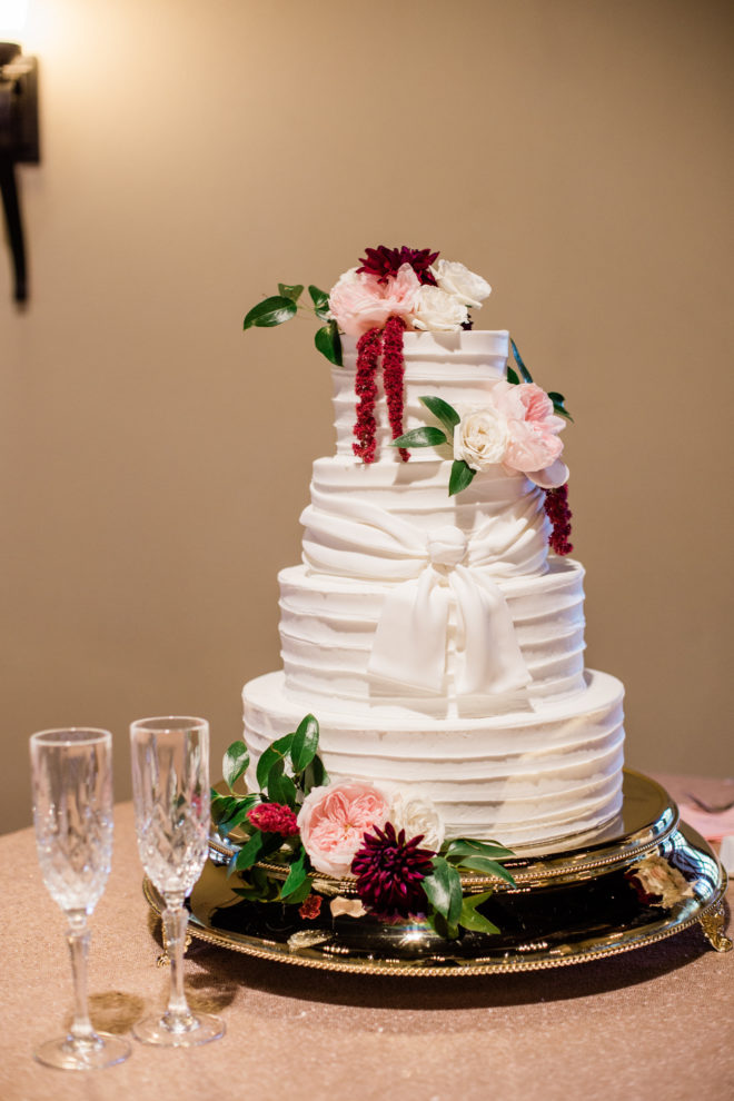 Blush and wine floral four tiered wedding cake 