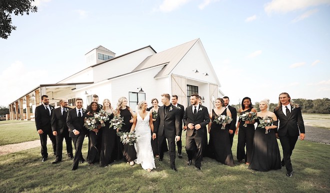 Couple , bridesmaids, and groomsmen at Deep In The Heart Farms. 