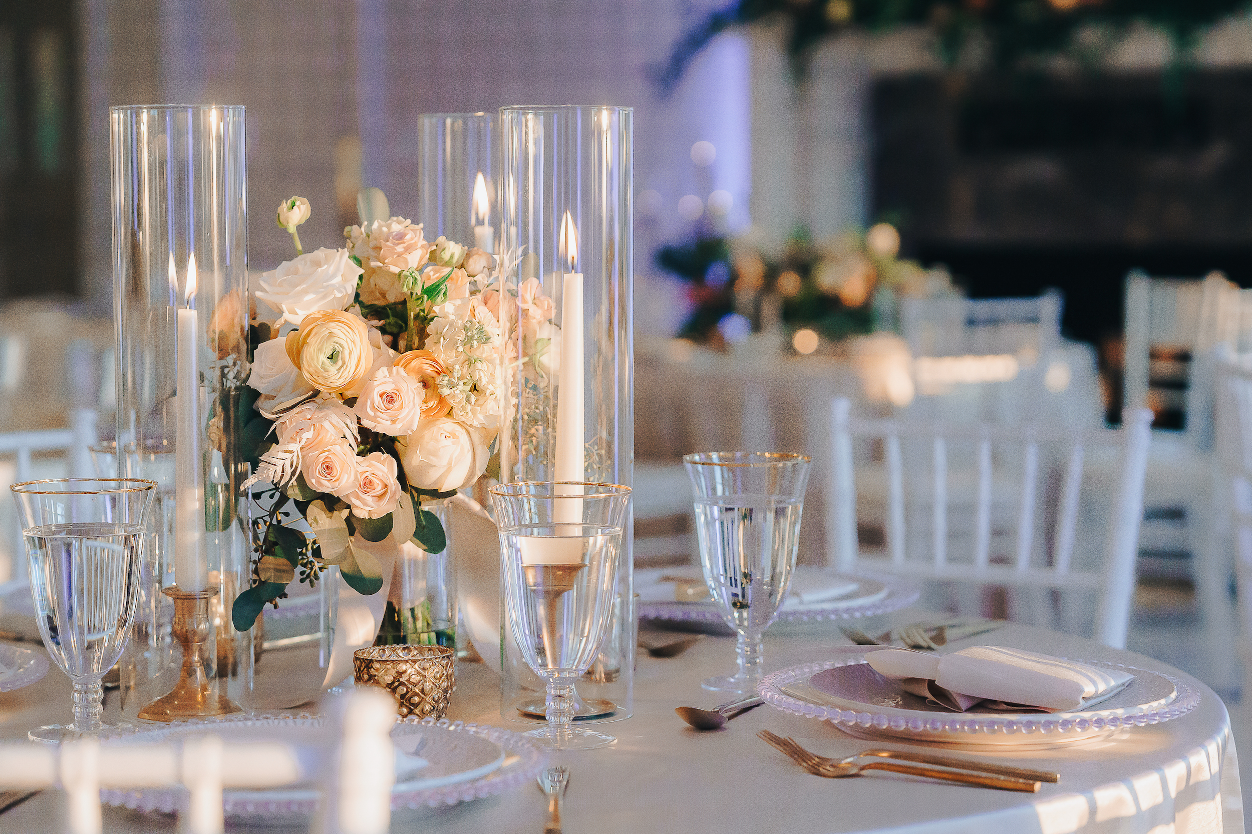 reception table decor, white and peach flowers and glass candle covers