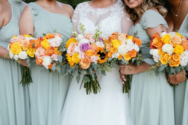 Multi-colored orange, white, and yellow bridesmaids bouquet. 