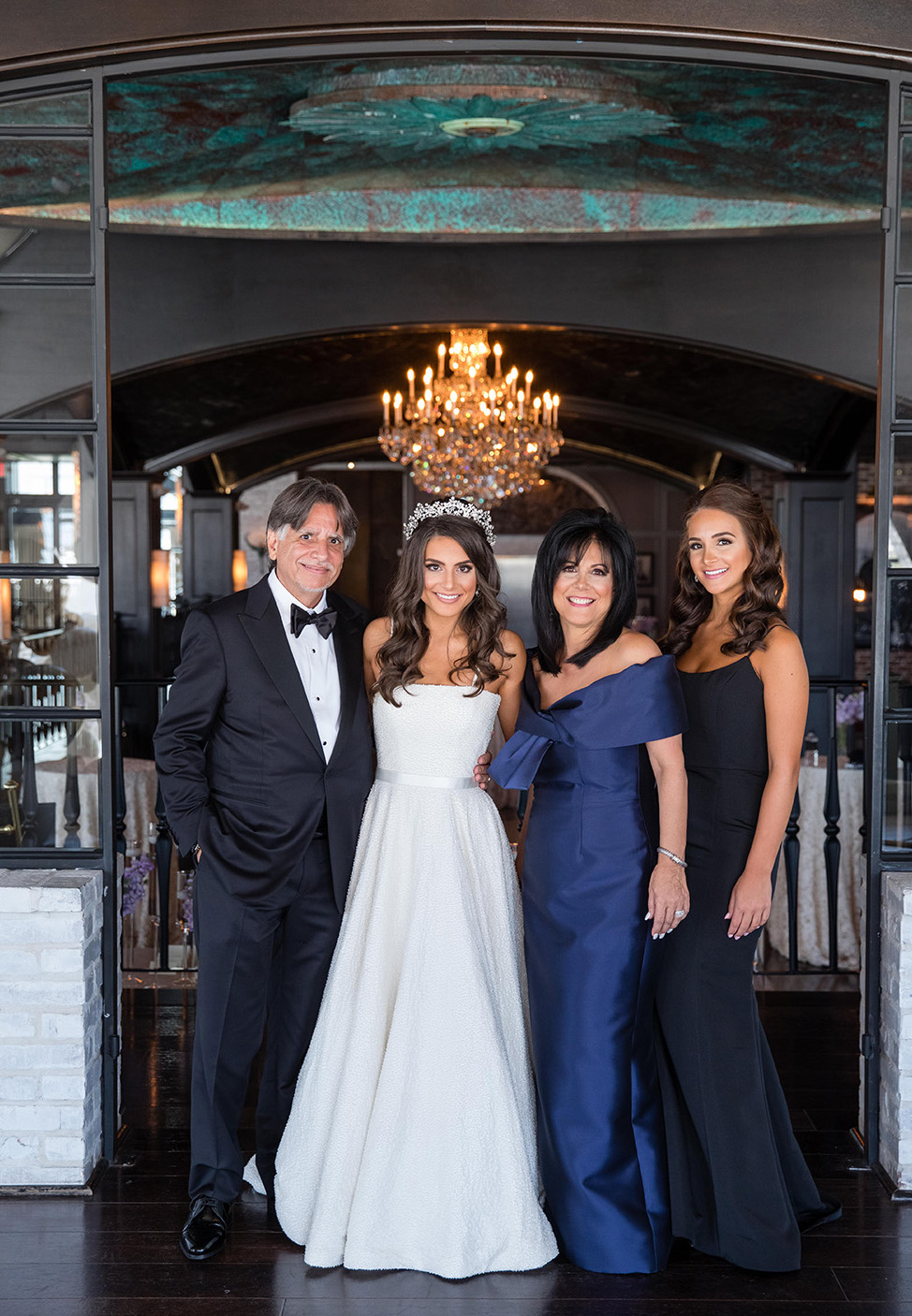 Bride and family takes photo in The Astorian before reception. 