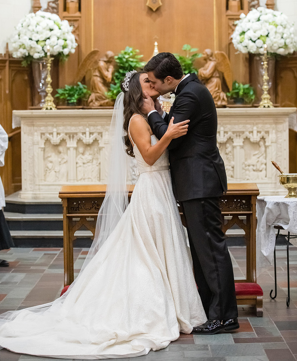 Bride and groom share a kiss at their ceremony. 