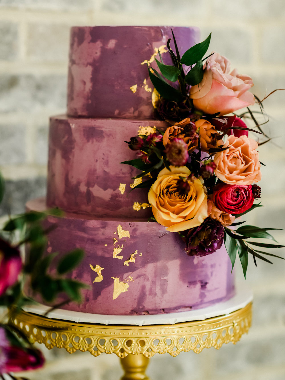 Becca's Cakes three tiered purple and gold accented cake. 