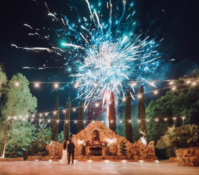 Bride and groom watching fireworks on outside patio of Madera Estates in Conroe, Texas