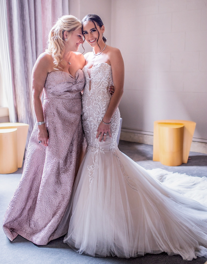 Mother of bride and bride share an intimate moment at a bridal lounge in the Corinthian Houston.