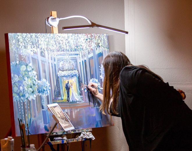 Artist paints a moment shared between the bride and groom on a canvas inside the Corinthian Houston. 