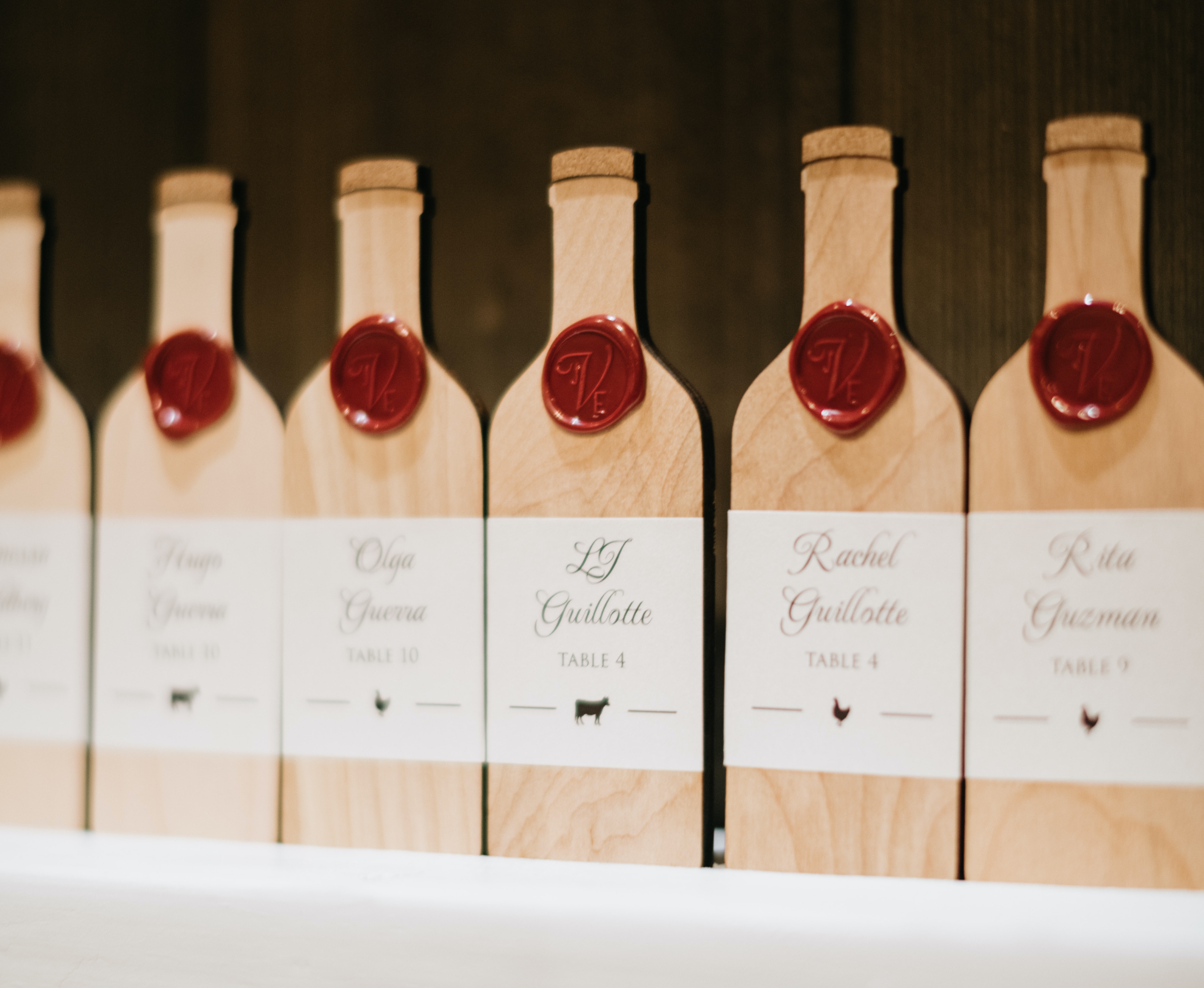 Custom guest list made out of wooden wine bottle cut-outs.