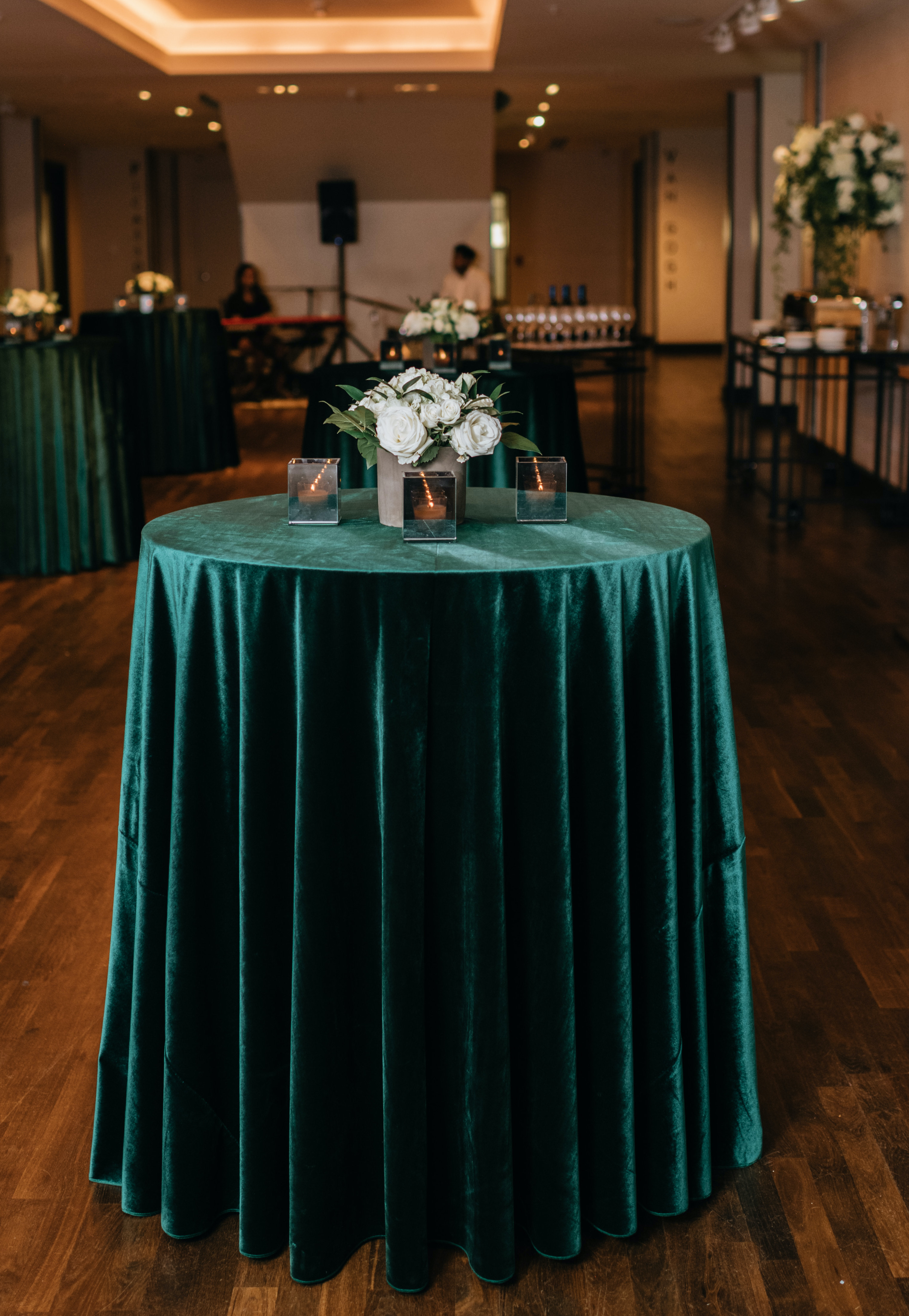 A velvety green table-cloth is draped over the cocktail table.