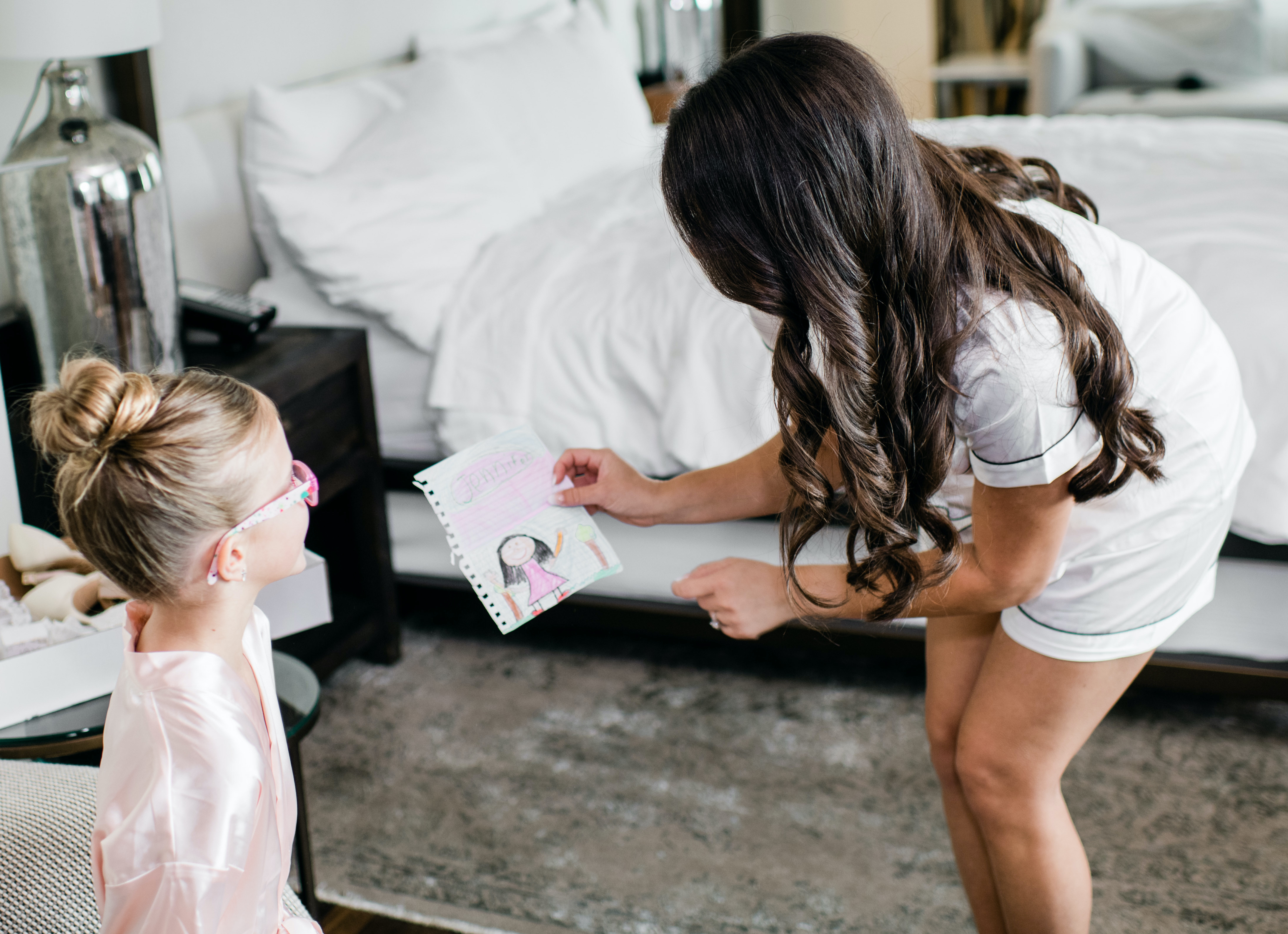 The flower girl gives the bride a drawing.