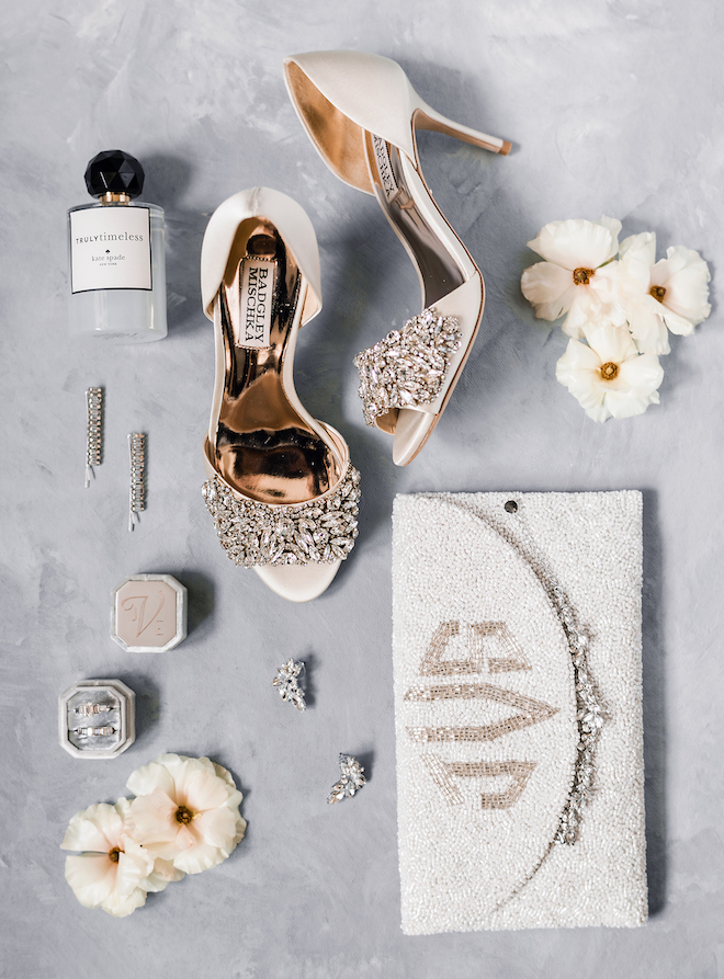 The bride's shoes with her accessories and beaded clutch at a downtown Houston wedding.