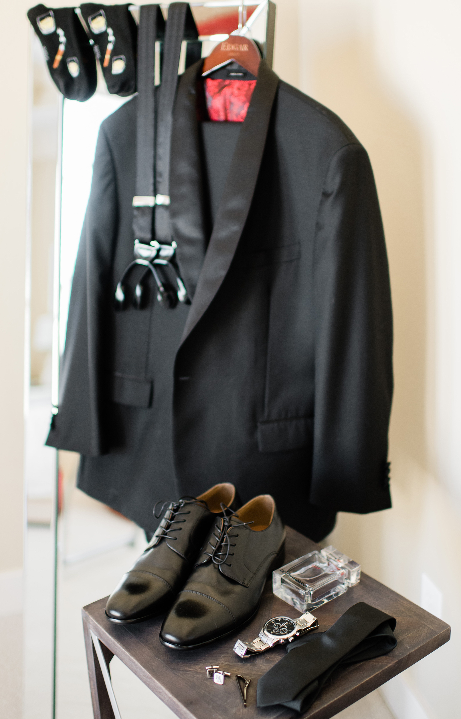 The groom's accessories and suit are set up for him to get dressed.