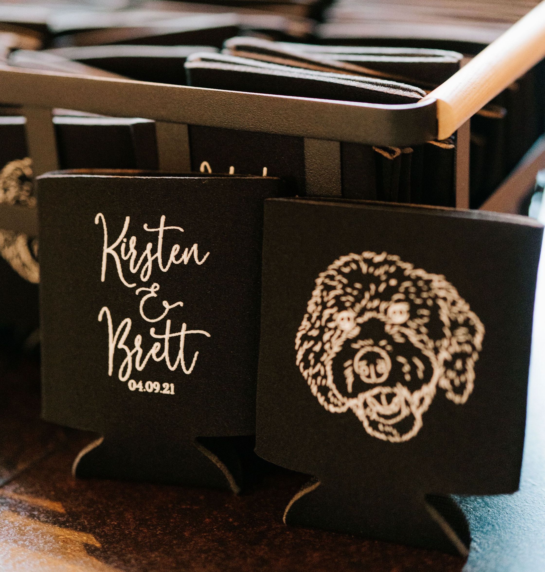 Kirsten and Brett's wedding favors were black can cozies with a cute white cartoon portrait of their dog, Moose.