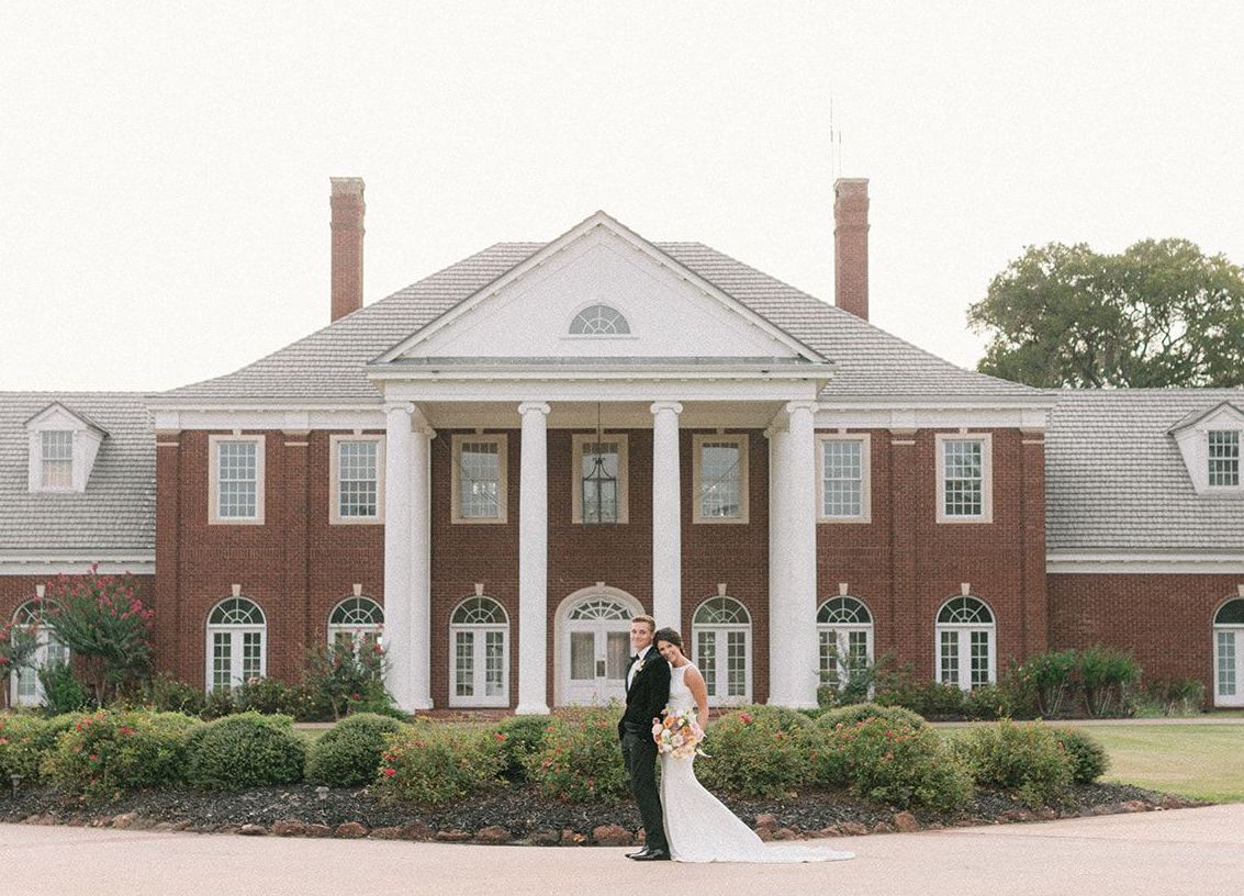 Bride and Groom stand in front of their southern venue, The Mansion at ColoVista, for their styled shoot.