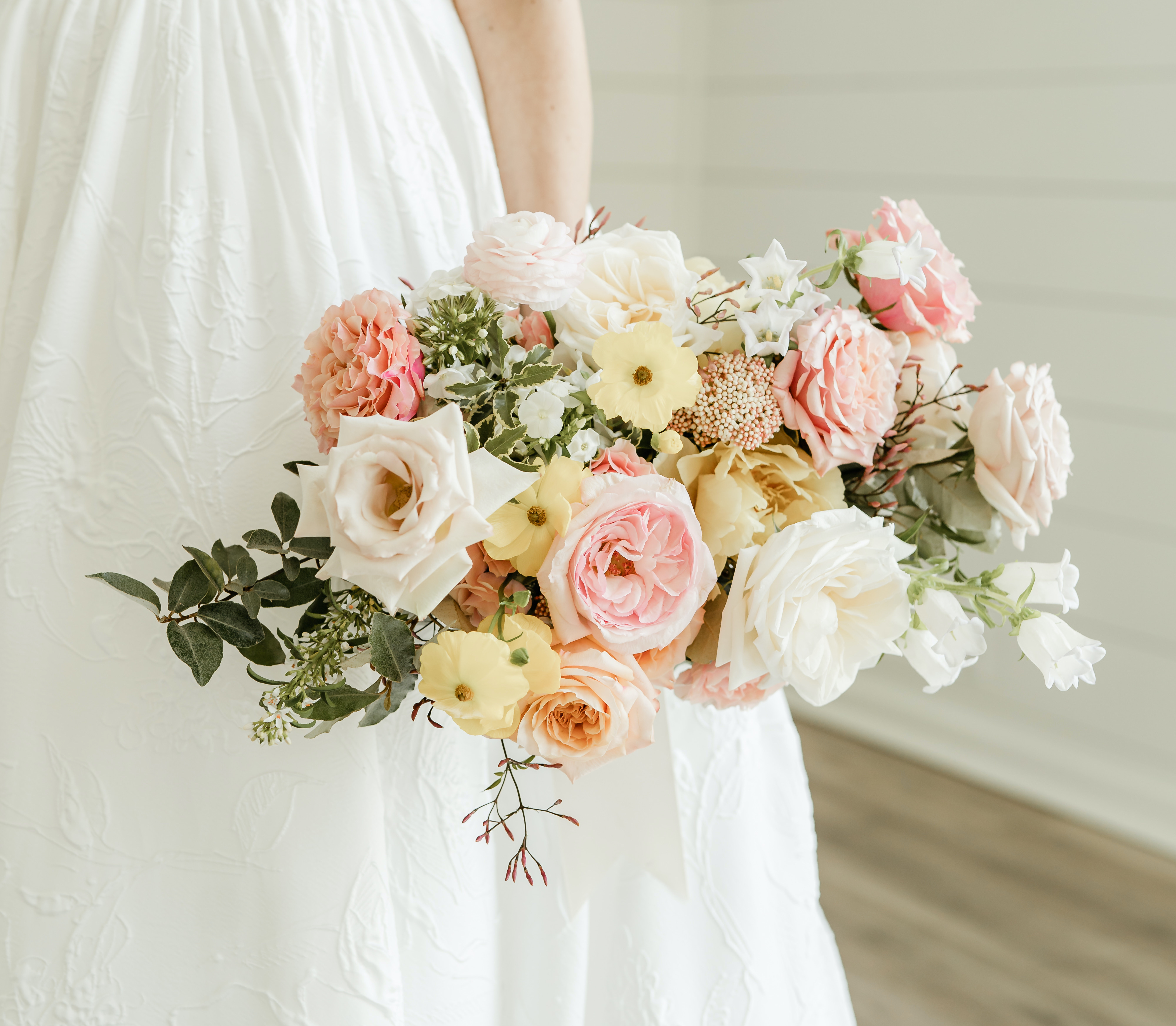 The bride's colorful bridal bouquet with pops of yellow and pink.