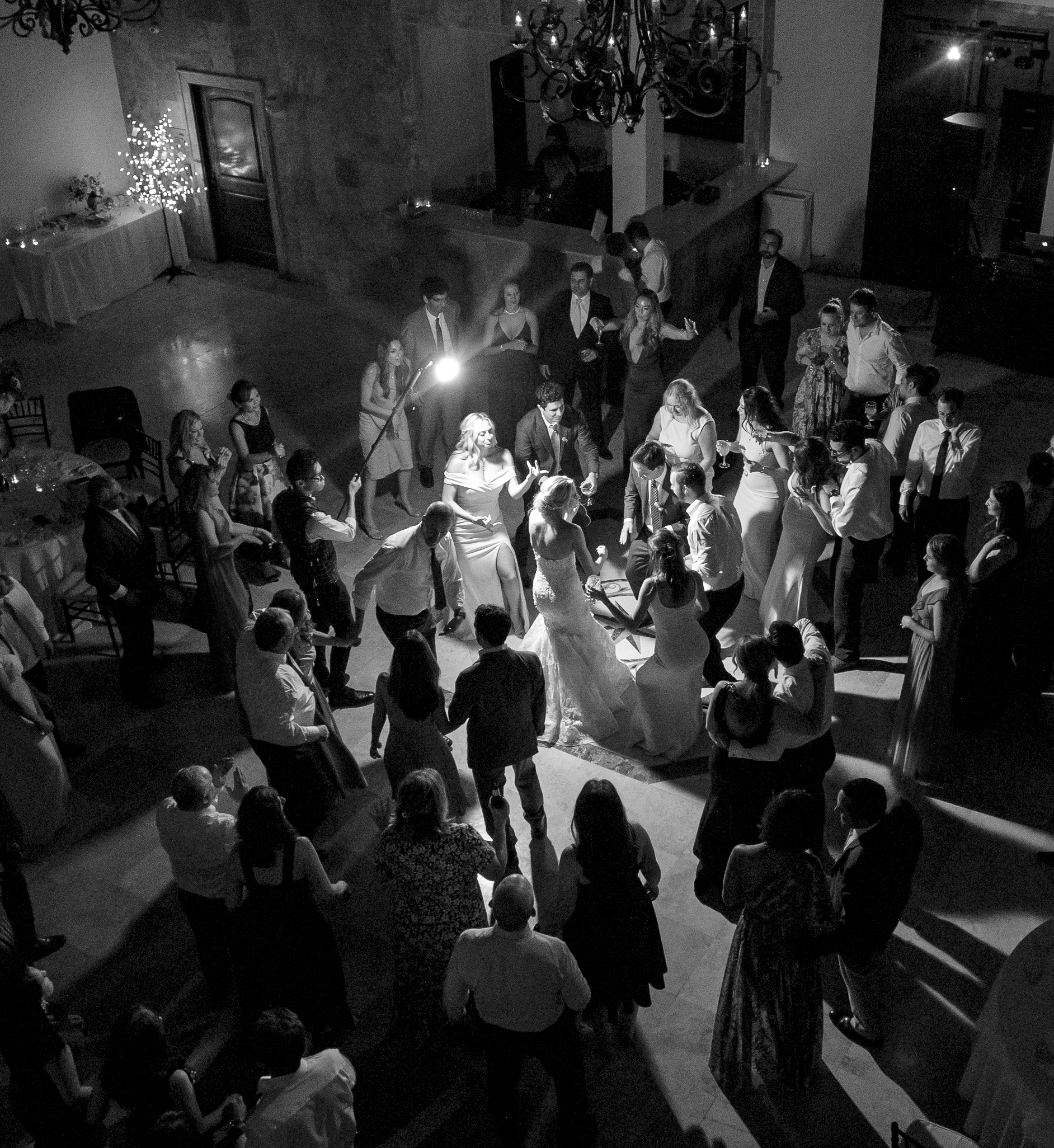 The bride and groom dancing at their wedding reception with their guests.