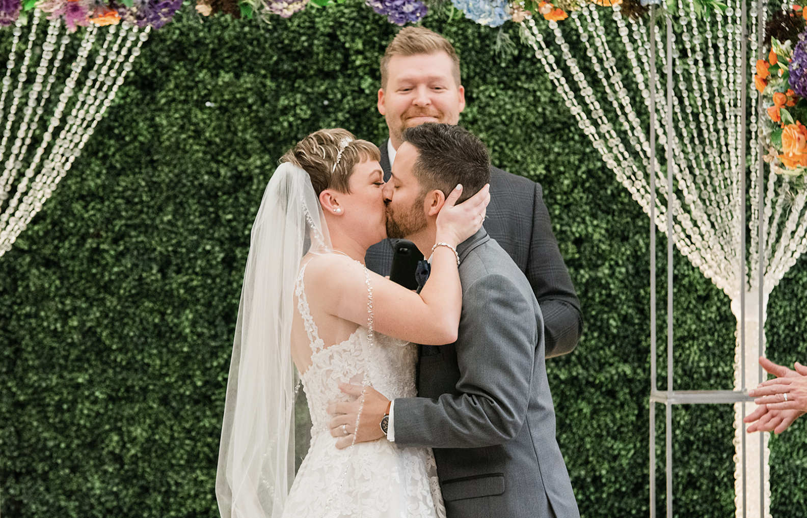 The bride and groom kiss at the altar.