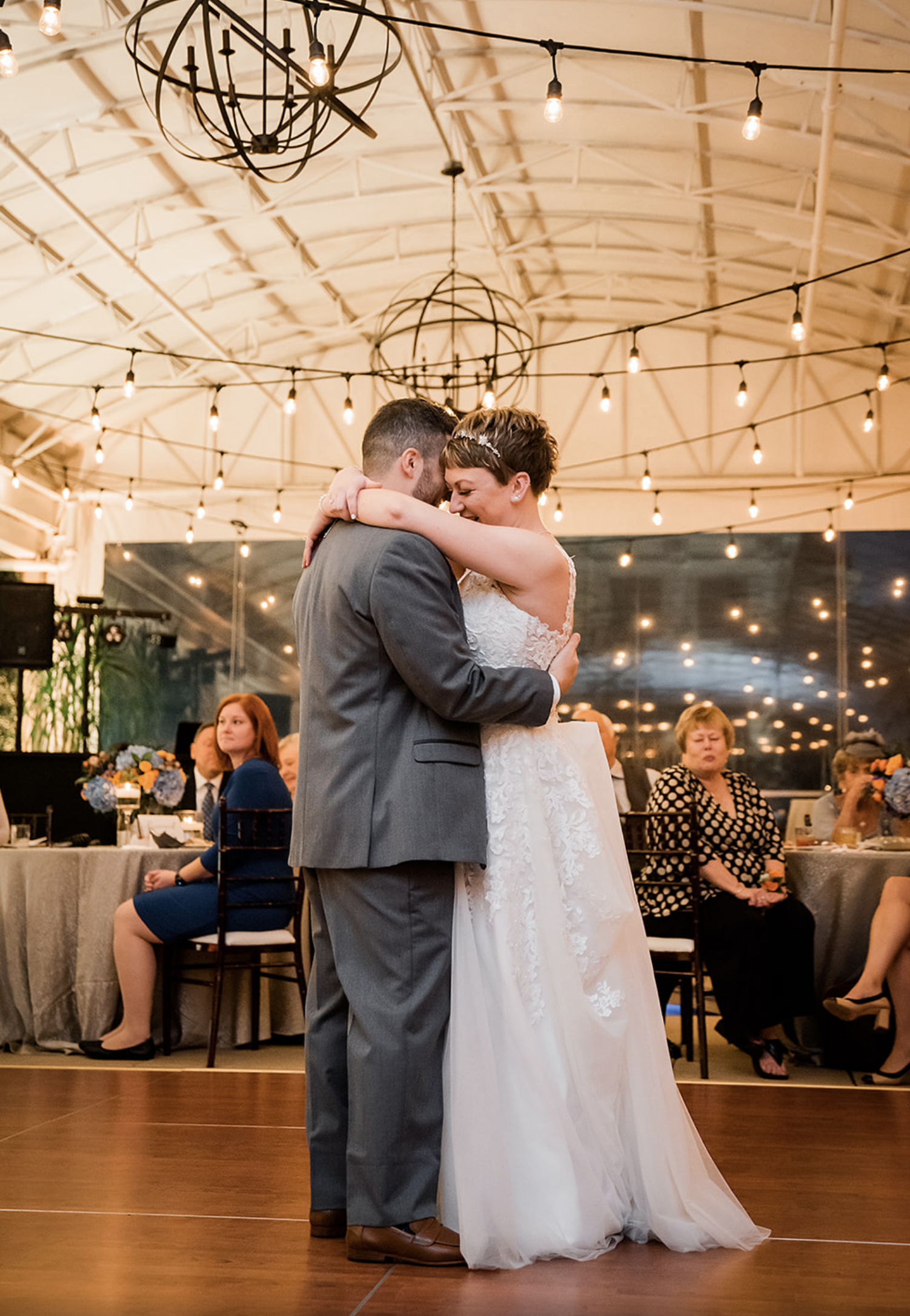 The bride and groom slow dance in front of their guests.