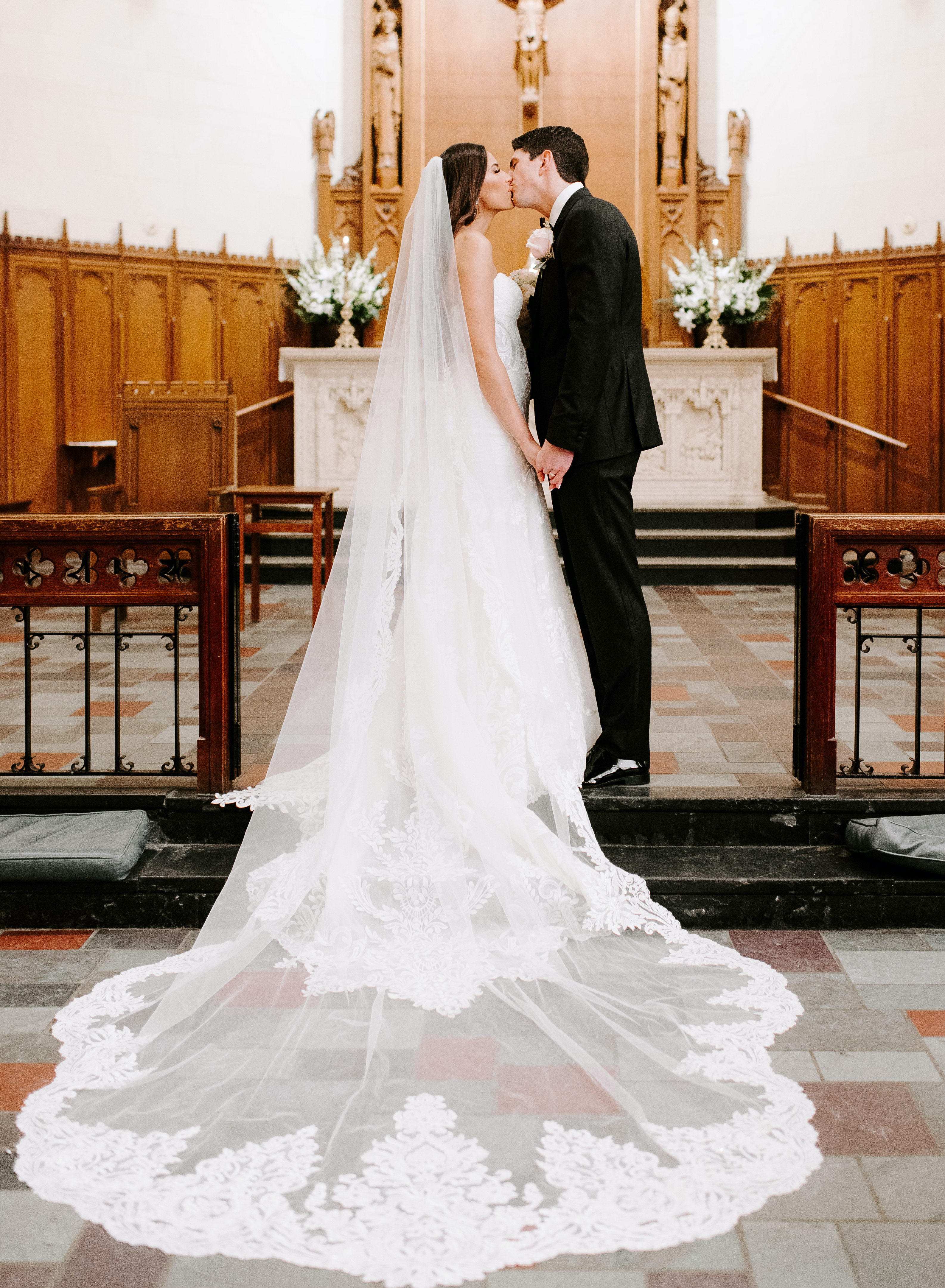 The bride and groom kiss at the altar.