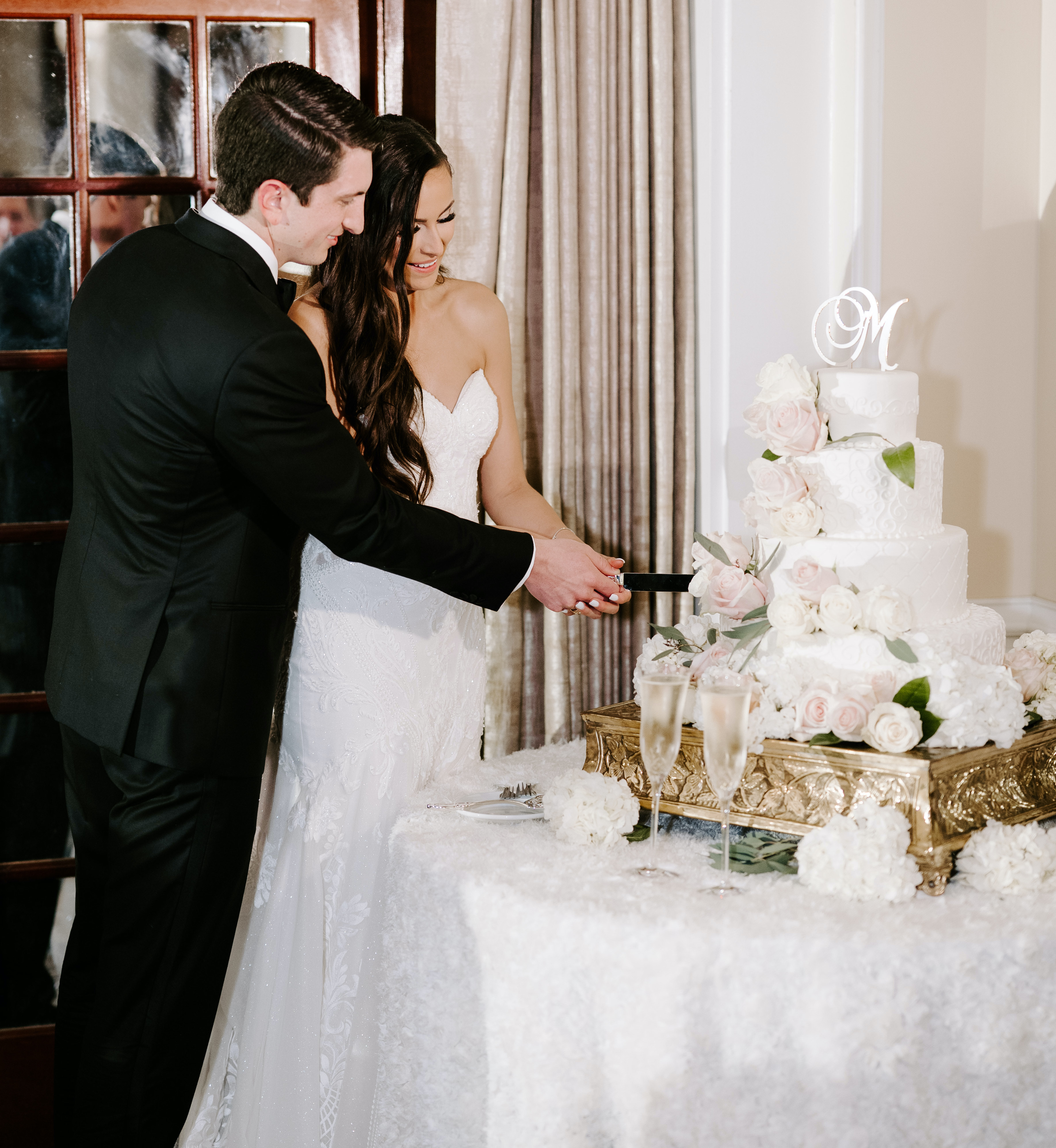 The bride and groom cutting the cake at their reception party.