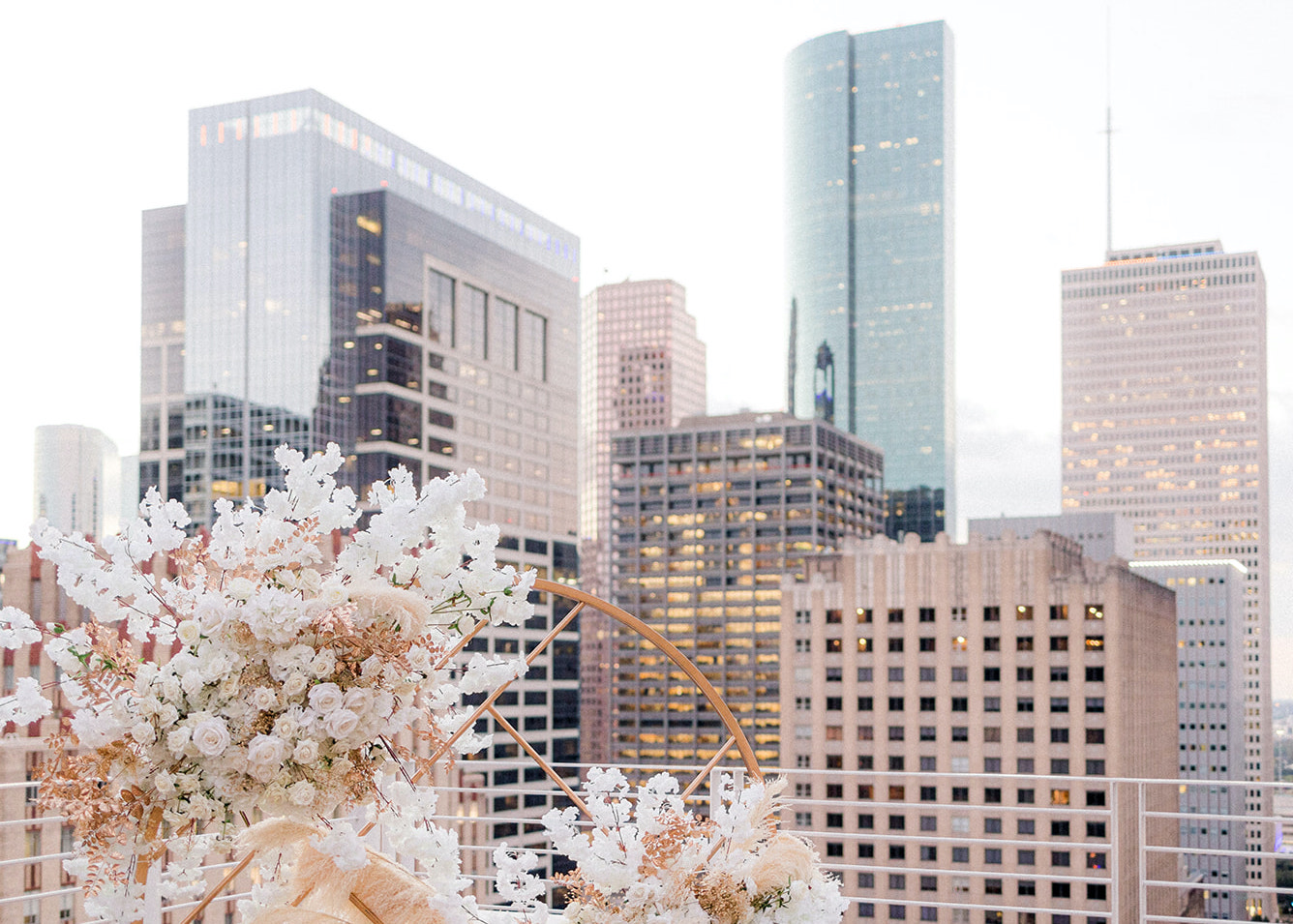 A view of the city from the rooftop with the styled shoot flower installation in the corner of the photo.