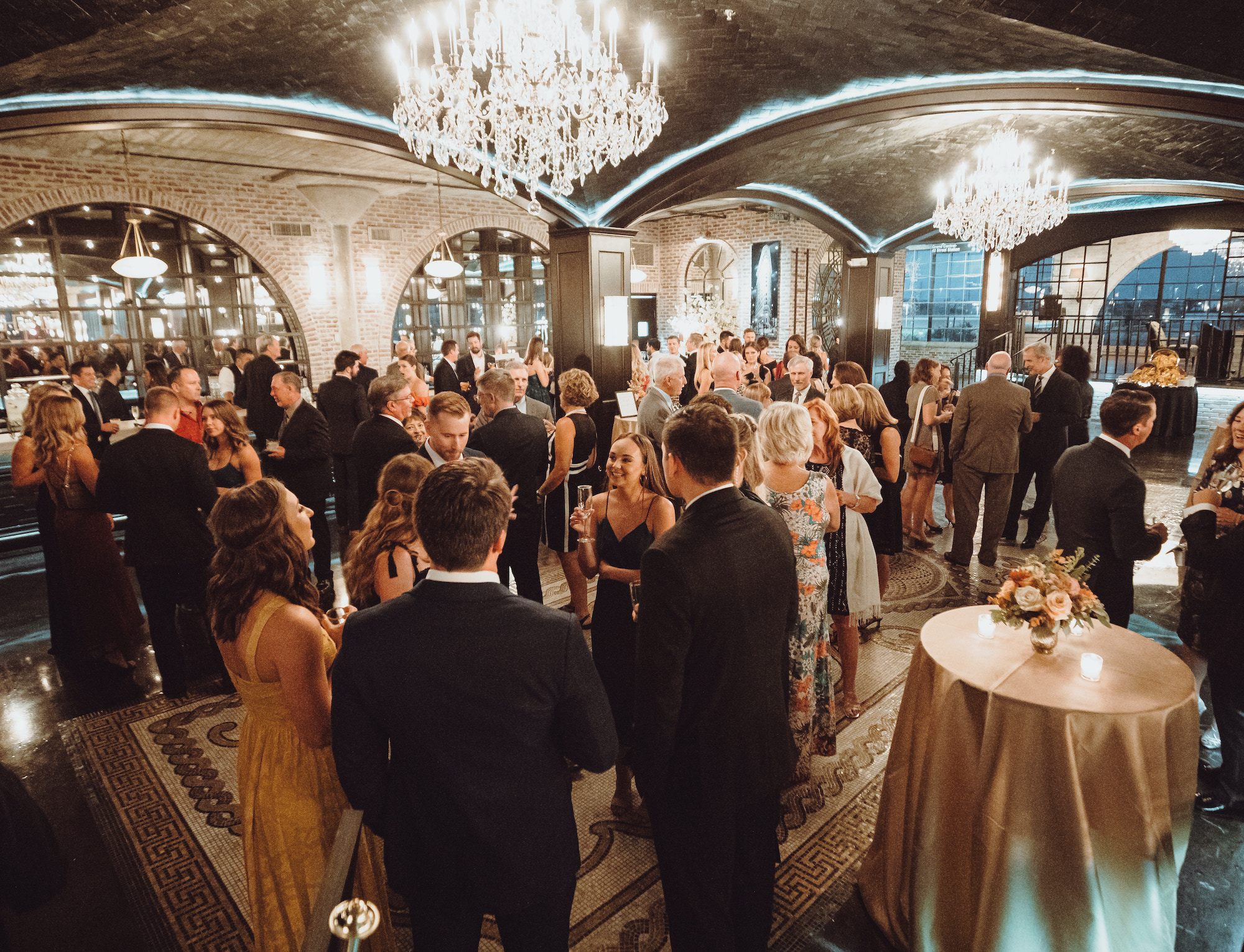 Wedding guests mingle at a wedding reception at The Astorian in Houston, TX.