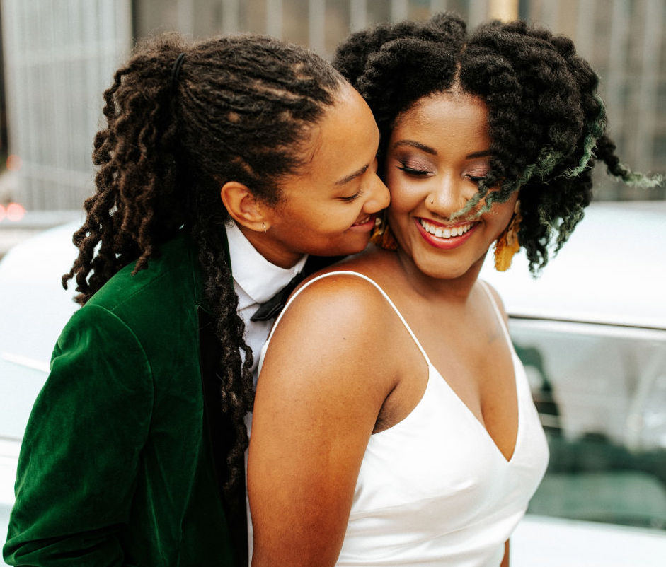 LGBT brides laugh and hug for a tropical havana inspired styled shoot.