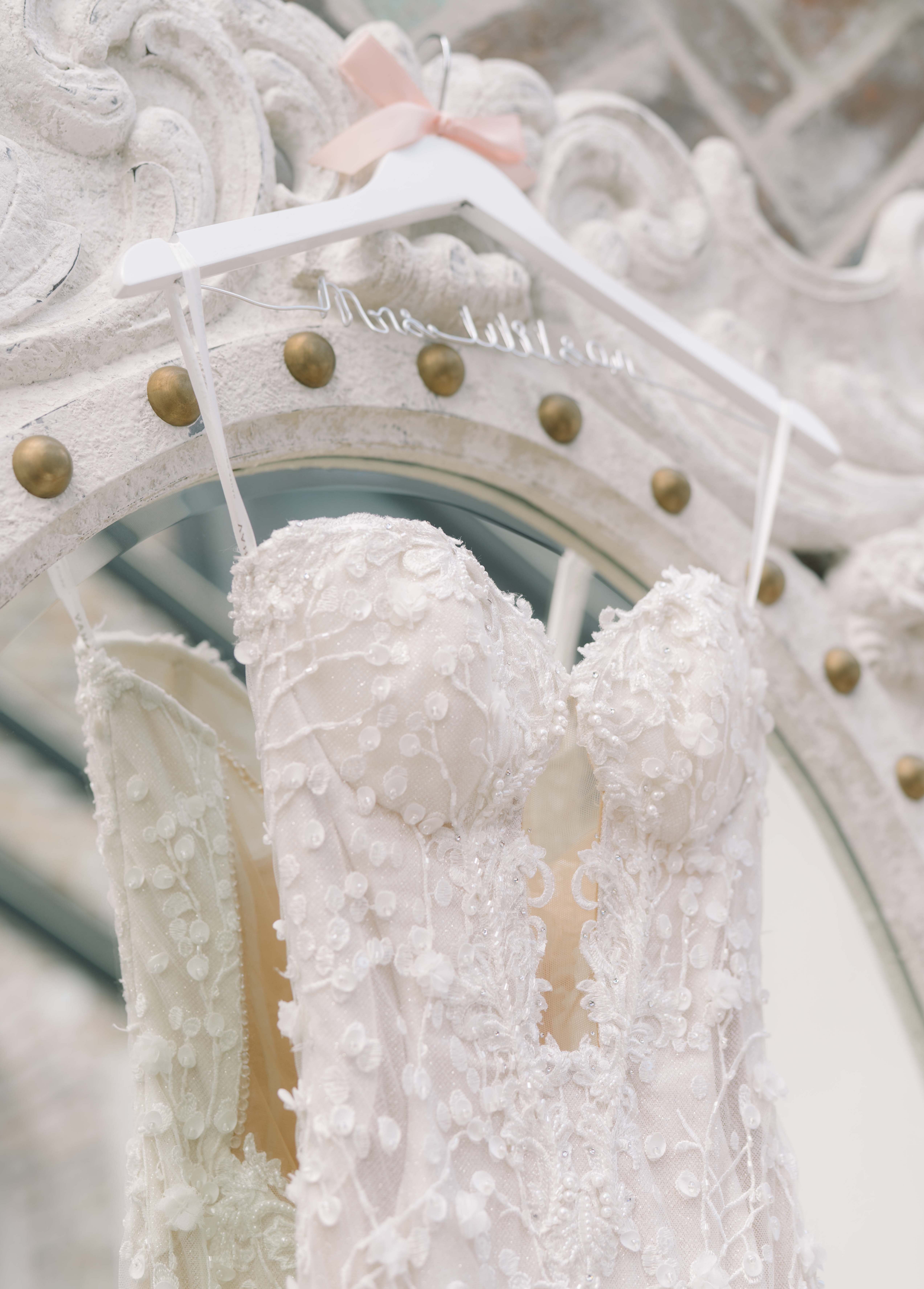 A bride's Galia Lahav gown is hanging for her before her wedding.