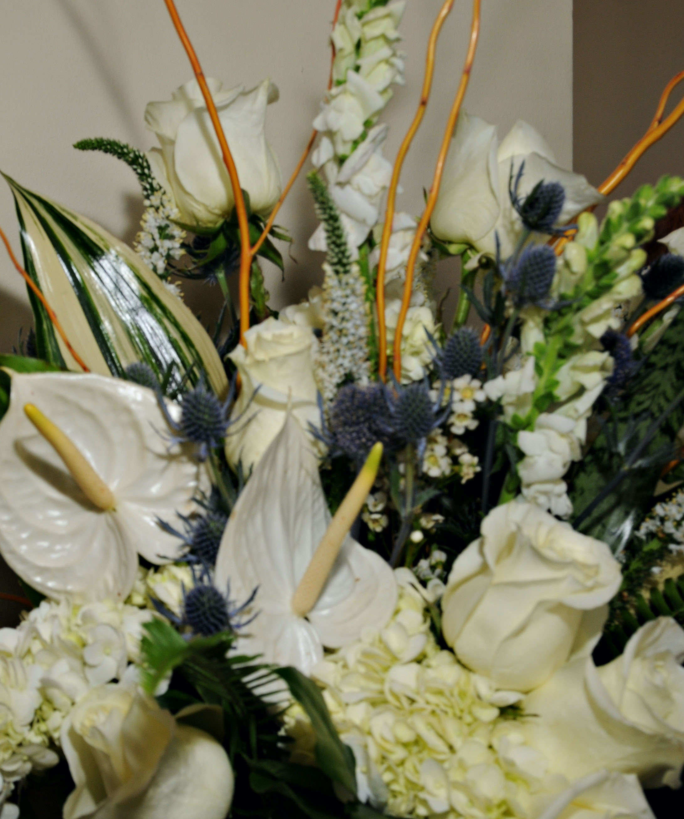 White wedding flowers with roses and greenery for a wedding at The Tremont House in Galveston.