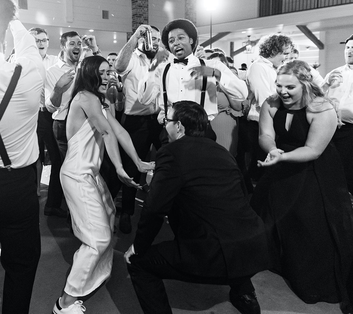 A bride and groom dance with their family and friends at their wedding reception in Montgomery, TX.