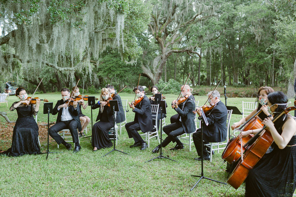 An orchestra plays outside in an alfresco wedding in the Lowcountry planned and executed by Tara Guérard Soirée.