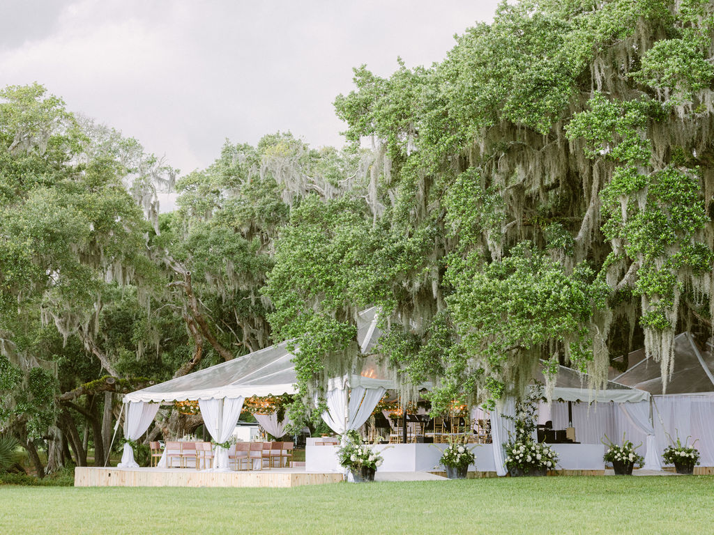 An outdoor wedding reception under in tent in Charleston, SC designed and executed by Tara Géurard Soirée