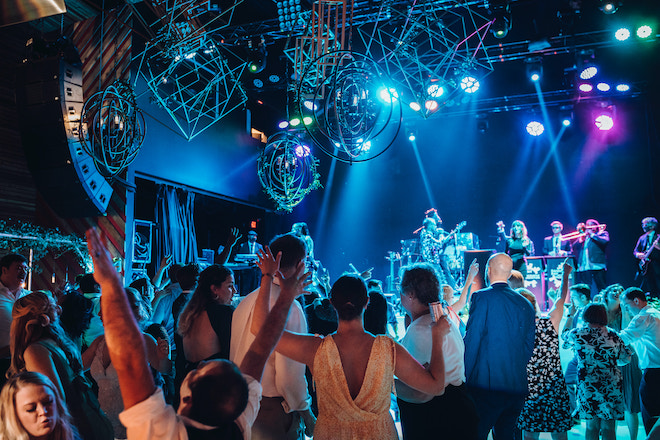 Wedding guests dance to music played by wedding band, Danny Ray and the Atlantic Street Band, during a wedding reception at White Oak Music Hall in Houston, TX.