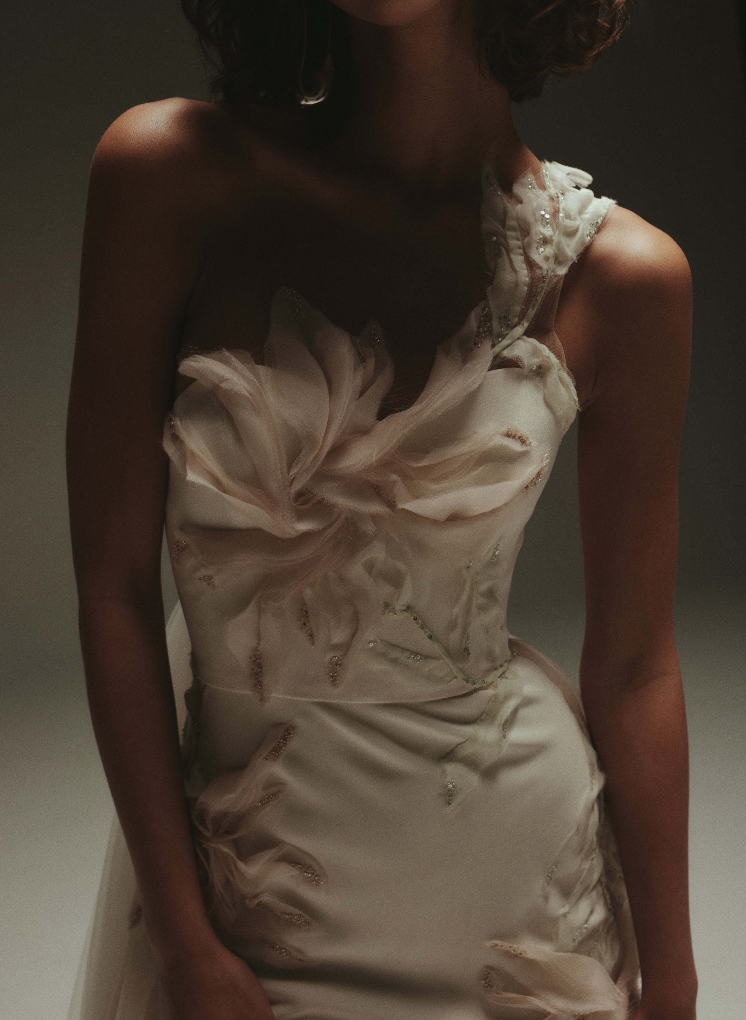 Single strap gown with blush stitched flowers and a tulle skirt.