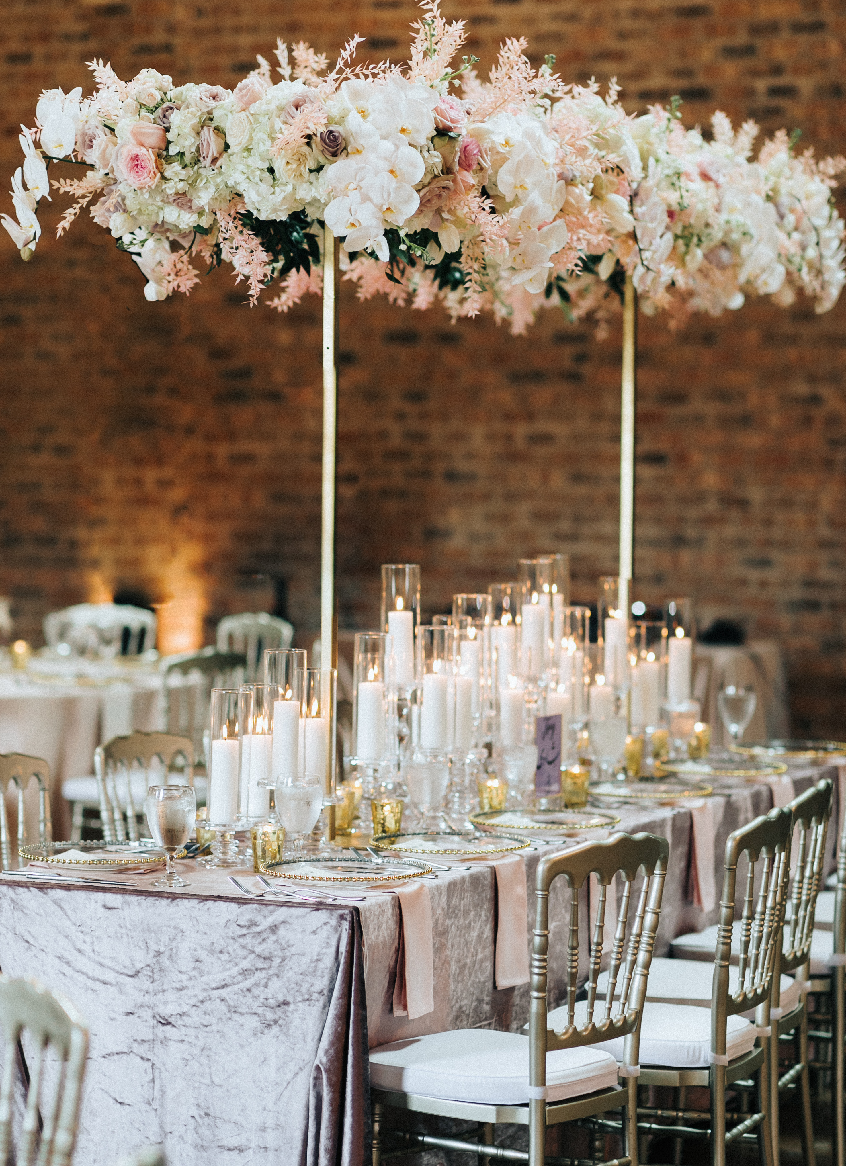 Pink and lilac flowers and decor are set up for a wedding reception at Iron Manor in Montgomery, TX.