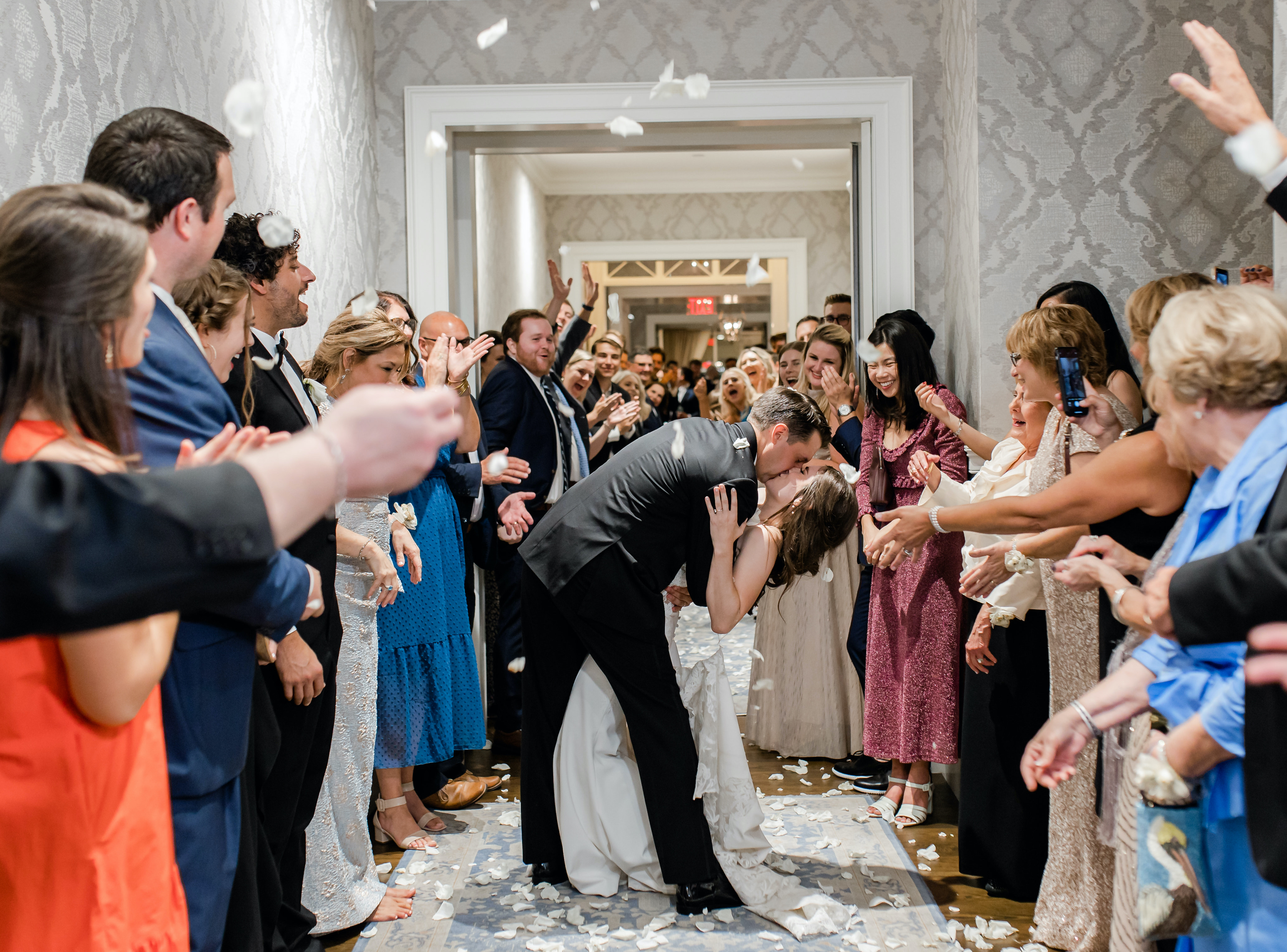 A bride and groom kiss in the aisle during their send off from their wedding reception.