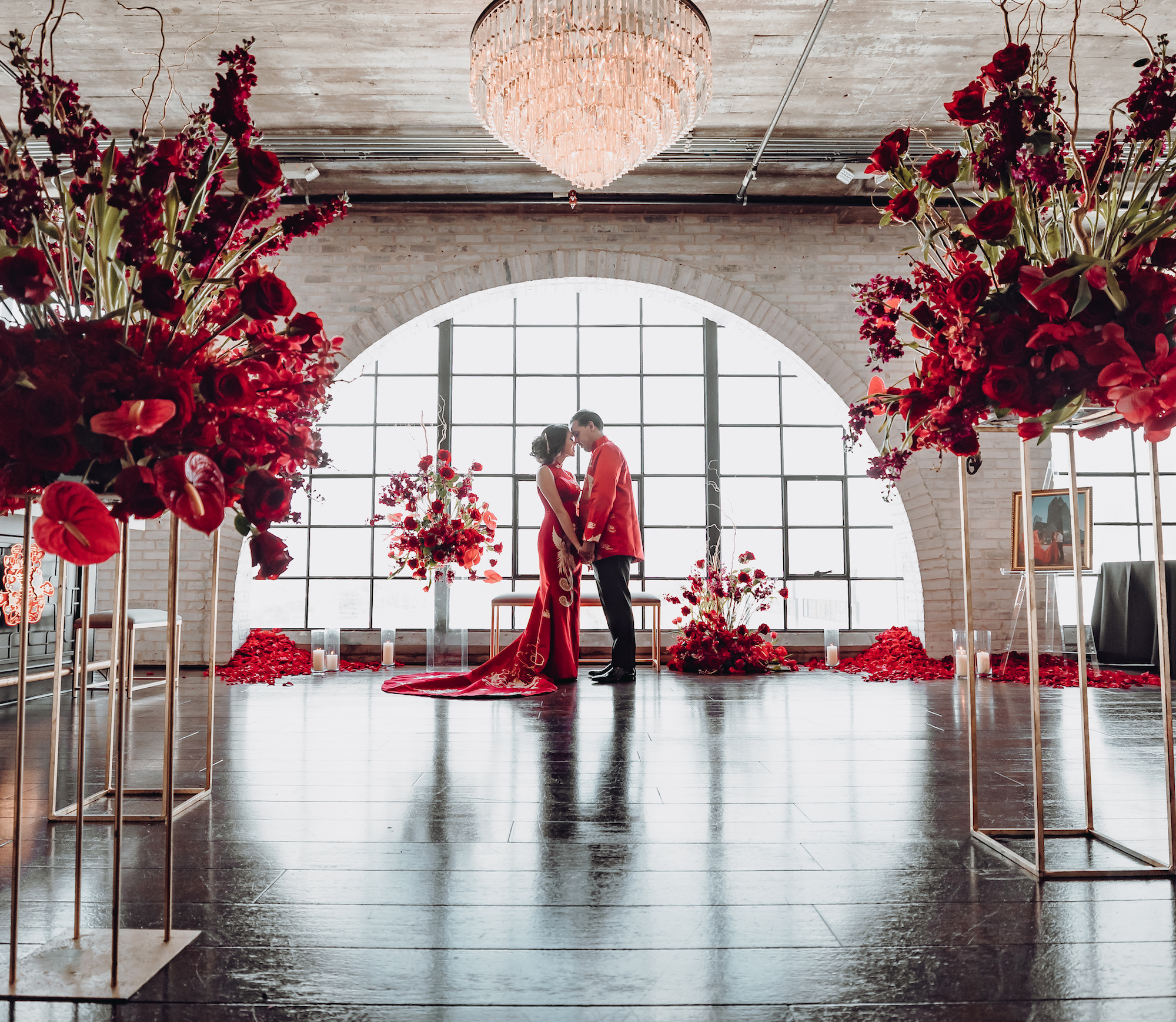 A bride and groom wear red garments to celebrate their chinese culture on their wedding day in Houston, TX.